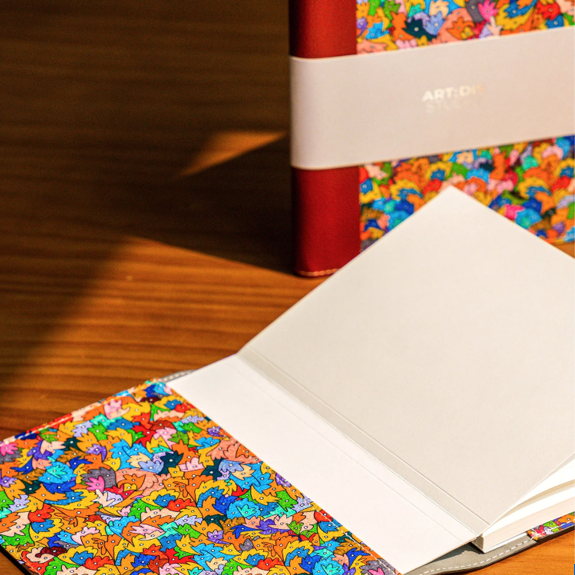Notebooks with designs by artists from ART:DIS